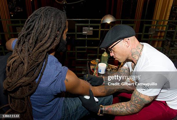 Ami James tattoos John Forte at The Ami James Ink Tattoo Pop-Up Shop at the Empire Hotel on February 9, 2012 in New York City.