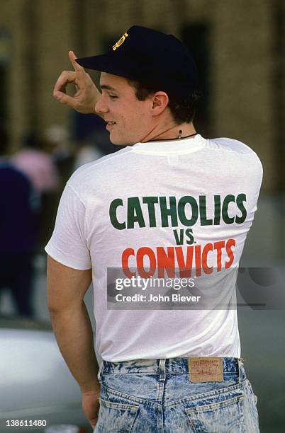 Rear view of Notre Dame fan wearing tee shirt that reads CATHOLICS VS CONVICTS before game vs Miami at Notre Dame Stadium. South Bend, IN CREDIT:...