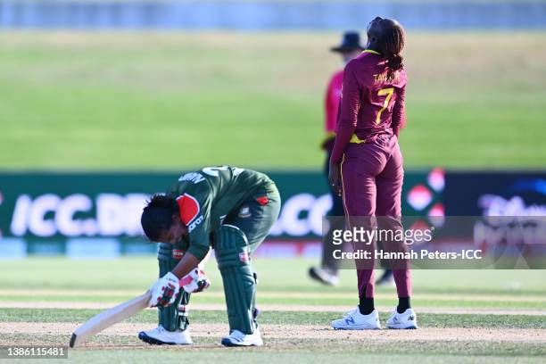 Stafanie Taylor of the West Indies reacts after winning as Nahida Akter of Bangladesh reacts after losing the 2022 ICC Women's Cricket World Cup...