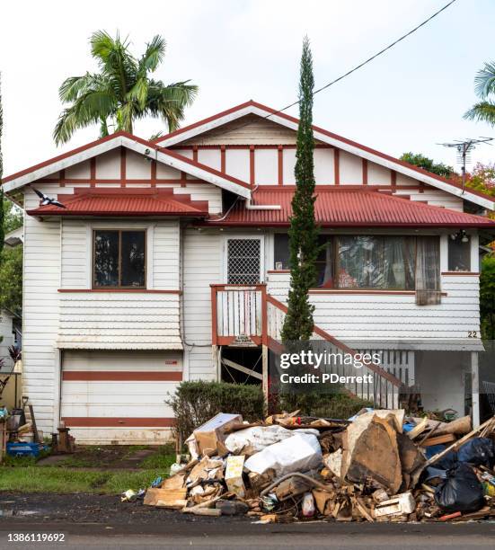 the worst floods in history have devastated the northern rivers city of lismore. debris awaits collection outside a sth lismore home. - house flood stock pictures, royalty-free photos & images