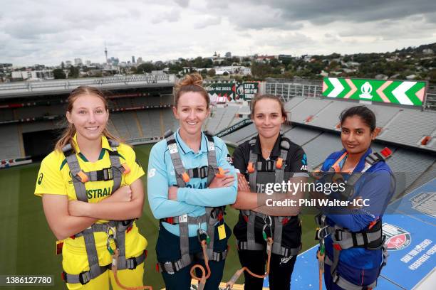 Darcie Brown of Australia, Kate Cross of England, Amelia Kerr of New Zealand and Mithali Raj of India pose on the roof of Eden Park during a 2022 ICC...