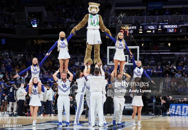 The Kentucky Wildcat performs with cheerleaders during the halftime break in the first round game of the 2022 NCAA Men's Basketball Tournament...