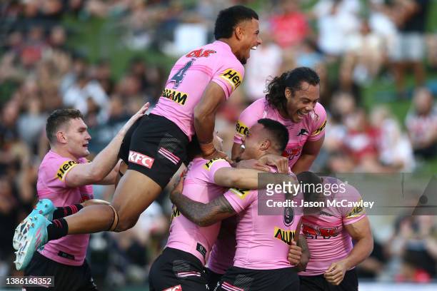 Spencer Leniu of the Panthers celebrates with team mates after scoring a try during the round two NRL match between the St George Illawarra Dragons...