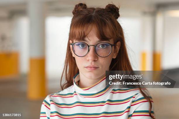 woman wearing  nerd glasses standing in underground parching - oranje haar stockfoto's en -beelden