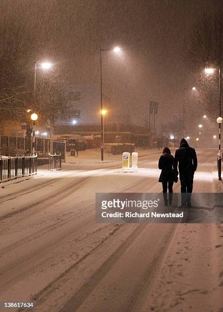 couple walking on road - mid distance stock pictures, royalty-free photos & images