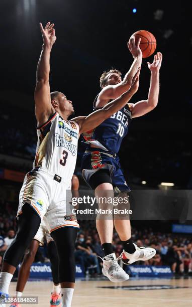 Mitch McCarron of the 36ers shoots for two over Scott Machado of the Taipans during the round 16 NBL match between Adelaide 36ers and Cairns Taipans...