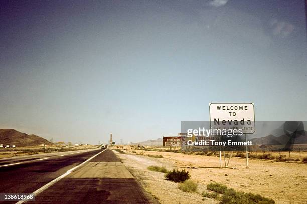 sign board of 'welcome to nevada' on road - nevada stock pictures, royalty-free photos & images