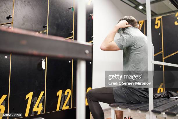 sportsman changing clothes in locker room - finishing workout stock pictures, royalty-free photos & images