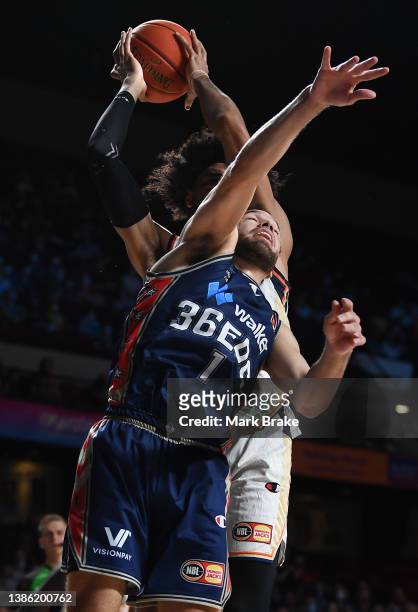 Keanu Pinder of the Taipans rebounds behind Tad Dufelmeier of the 36ers during the round 16 NBL match between Adelaide 36ers and Cairns Taipans at...