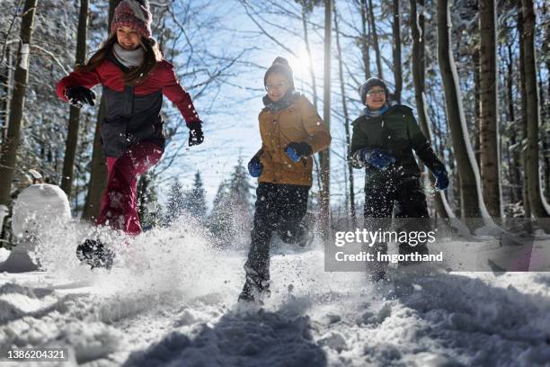 happy kids running in beautiful winter forest on a sunny day - girl hiking stock pictures, royalty-free photos & images