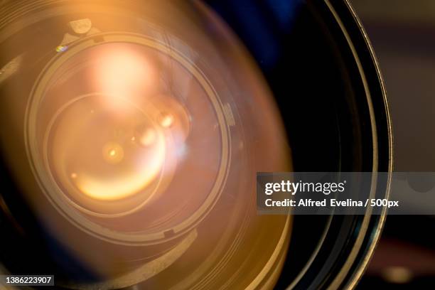 lens of the photo objective close-up of illuminated lighting equipment - camera shutter stock-fotos und bilder