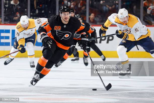 Travis Konecny of the Philadelphia Flyers skates with the puck against the Nashville Predators at Wells Fargo Center on March 17, 2022 in...