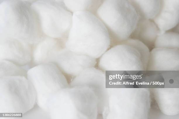 group of cotton balls on white background - alfred weiss stock-fotos und bilder