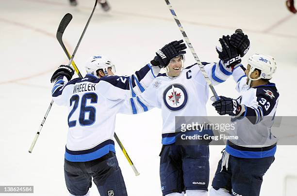 Dustin Byfuglien of the Winnipeg Jets celebrates with Andrew Ladd and Blake Wheeler after scoring in the third period against the Washington Capitals...