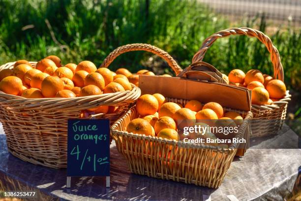 valencia juice oranges for sale at roadside farm stand. - valencia basket stock-fotos und bilder