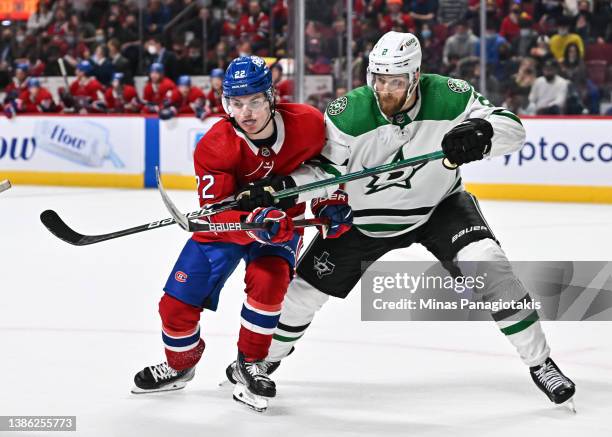Cole Caufield of the Montreal Canadiens and Jani Hakanpaa of the Dallas Stars skate against each other during the overtime period at Centre Bell on...