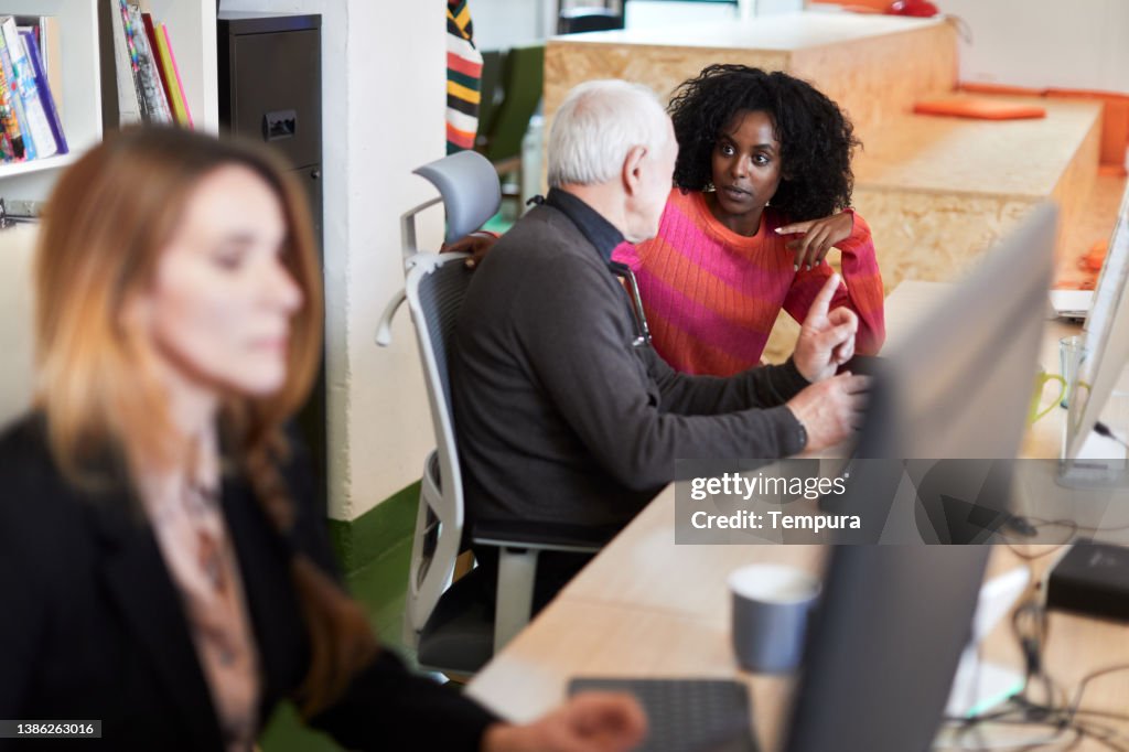 They are discussing business matters with a colleague.