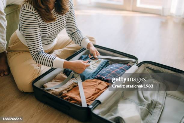 asian woman packing suitcase at home for journey in vacation day. - open rucksack stock pictures, royalty-free photos & images