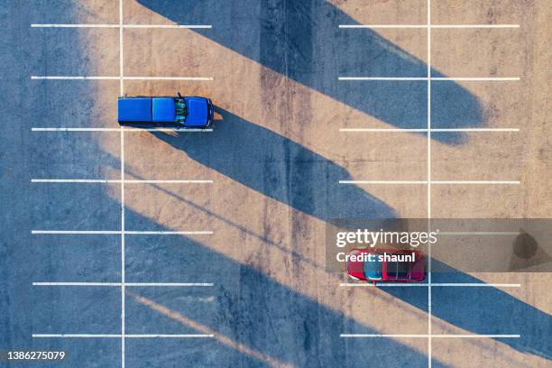 long shadows in parking lot - car underside stock pictures, royalty-free photos & images