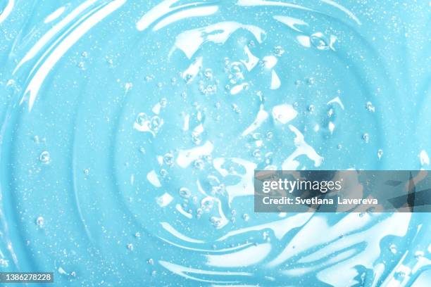 abstract texture. liquid gel cosmetics with little bubbles. blue background. face cream. close-up. cosmetics product. - 水生生物 個照片及圖片檔