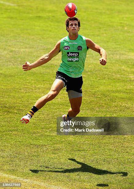 Trent Cotchin of the Tigers thumps the ball forward during a Richmond Tigers AFL intra-club training session match at Whitten Oval on February 10,...