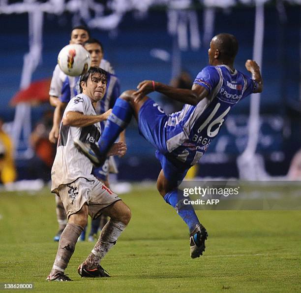 Oswaldo Hobecker of Paraguay's Olimpia vies for the ball with Oscar Bagui of Ecuador's Emelec during their Copa Libertadores football match at...