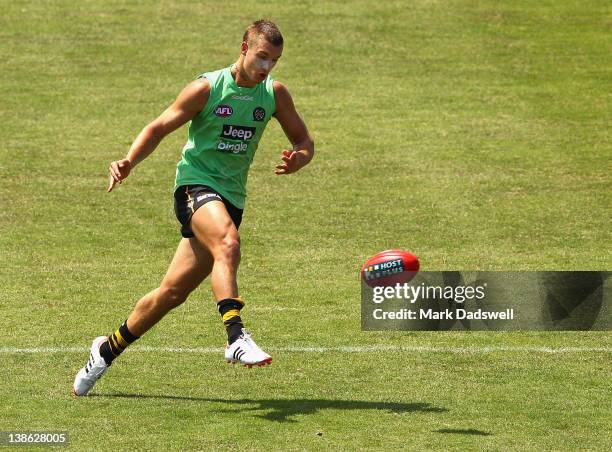 Dustin Martin of the Tigers passes the ball during a Richmond Tigers AFL intra-club training session match at Whitten Oval on February 10, 2012 in...