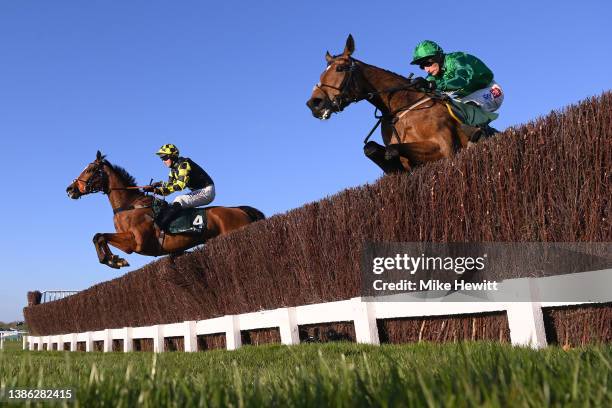 Daniel Jacob and Zambella jump the third last with Sam Coltherd and Maid O'Malley on day four of the Cheltenham Festival 2022 at Cheltenham...