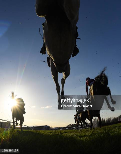 Runners and riders jump the third last in the Mrs Paddy Power Mares' Chase on day four of the Cheltenham Festival 2022 at Cheltenham Racecourse on...