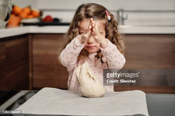 little girl drops a pizza dough on the table - pizza toss foto e immagini stock