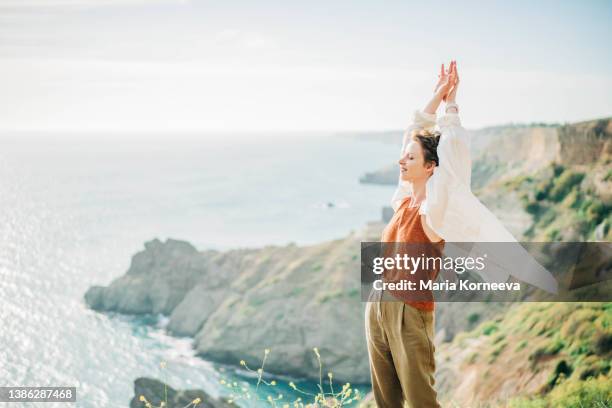 dreamy portrait of a young woman against the sea. - woman fresh air photos et images de collection