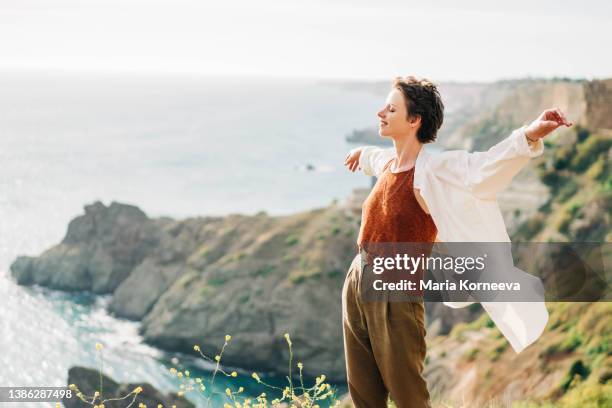 dreamy portrait of a young woman against the sea. - kostenlos stock-fotos und bilder