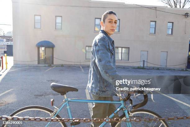 non-binary person walking a bicycle - indian transgender stock pictures, royalty-free photos & images