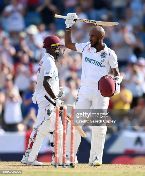 West Indies captain Kraigg Brathwaite celebrates reaching his century with Jermaine Blackwood during day three of the 2nd test match between West...