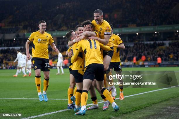 Francisco Trincao of Wolverhampton Wanderers celebrates after scoring their side's second goal with Rayan Ait-Nouri and Conor Coady during the...