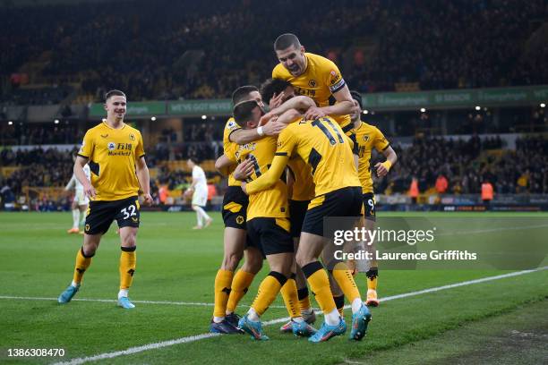 Francisco Trincao of Wolverhampton Wanderers celebrates after scoring their side's second goal with Daniel Podence and Conor Coady during the Premier...