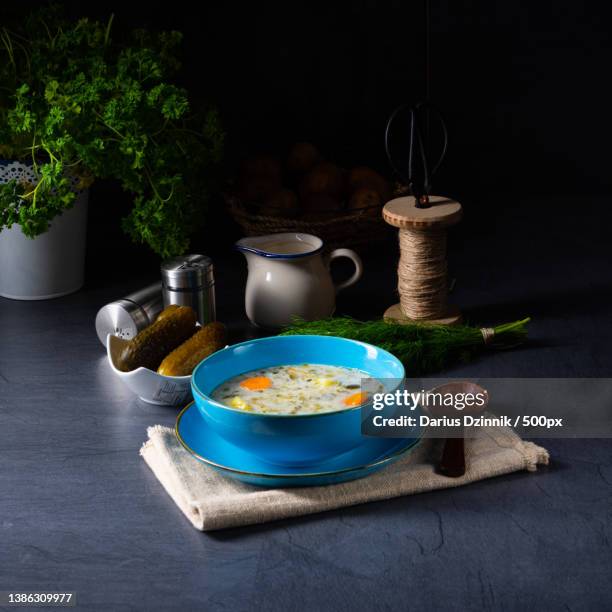 polish sour cucumber soup on black background - holzhintergrund stock pictures, royalty-free photos & images