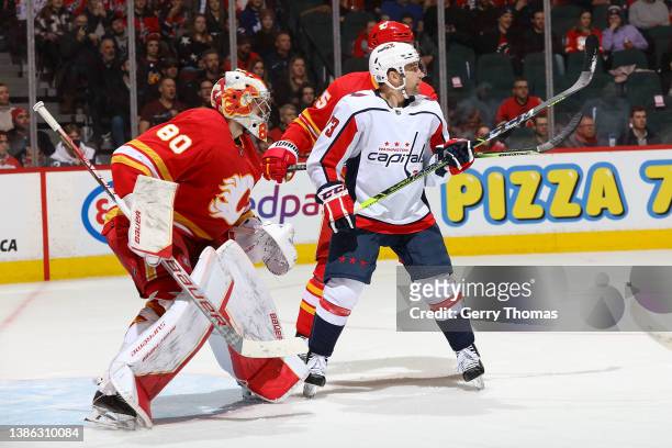 Dan Vladar of the Calgary Flames battles against Conor Sheary of the Washington Capitals at Scotiabank Saddledome on March 8, 2022 in Calgary,...