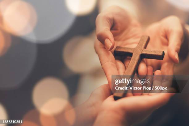 womans hand with cross cropped hands of woman - präst bildbanksfoton och bilder