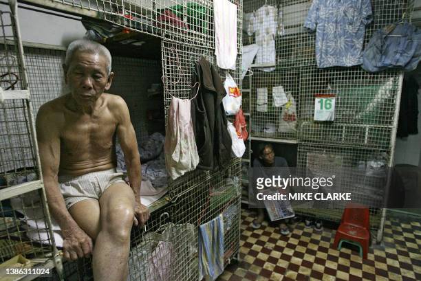 Hongkong-handover-10years-economy This picture taken 14 May, 2007 shows 78-year-old Tai Yum-po sitting in a "cage dwelling", in one of the world's...