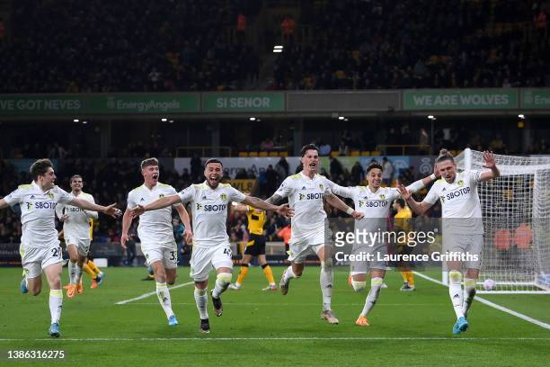 Luke Ayling of Leeds United celebrates after scoring their side's third goal with Robin Koch and Rodrigo Moreno during the Premier League match...