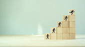 Competence skills and personal development concept. Human resource management(HRM). Knowledge, skill training and experience. Wooden cubes stairs with competency development icon on grey background.