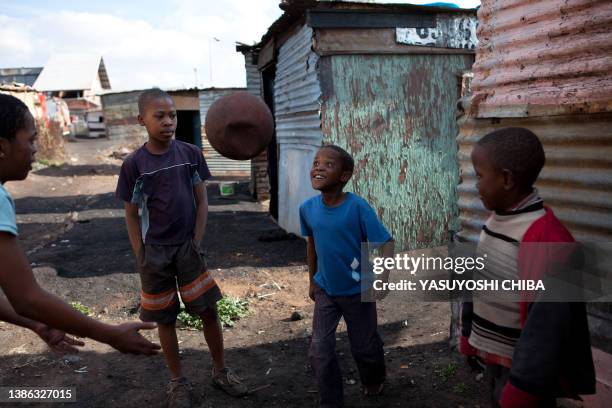 Children play football in Soweto on June 12, 2009 two days ahead of the opening match of the FIFA Confederations Cup in Johannesburg. A visit by...