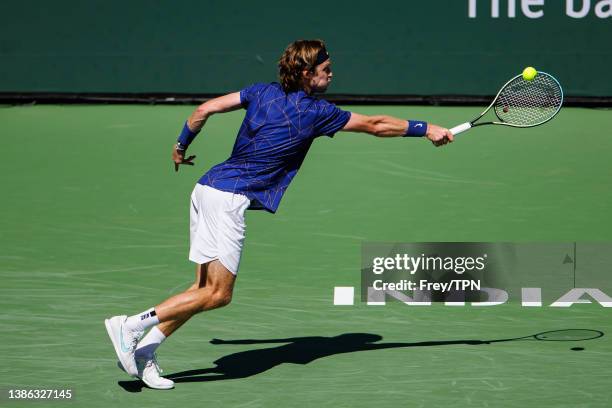 Andrey Rublev of Russia hits a backhand against Grigor Dimitrov of Bulgaria in the quarter final of the BNP Paribas Masters on March 18, 2022 in...