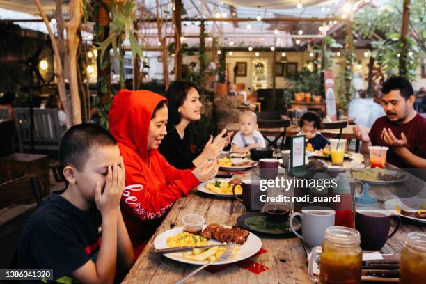 family eating iftar and enjoying breaking of fasting - indian family dinner table stock pictures, royalty-free photos & images