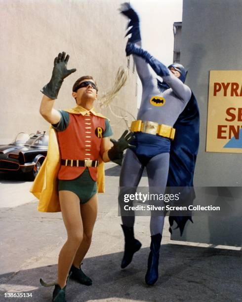 Burt Ward, US actor, and Adam West, US actor, both in costume as the 'Dynamic Duo' in a publicity still issued for the television series, 'Batman',...