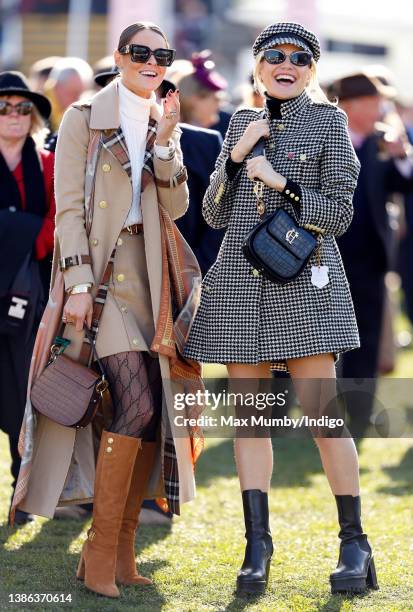 Jade Holland Cooper and Pixie Lott watch the racing as they attend day 4 'Gold Cup Day' of the Cheltenham Festival at Cheltenham Racecourse on March...