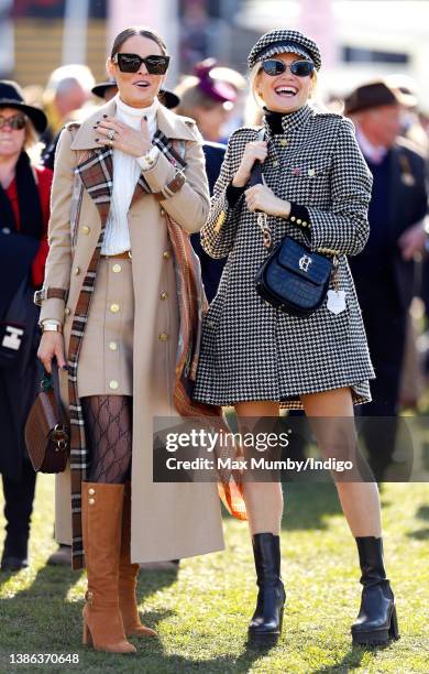 Jade Holland Cooper and Pixie Lott watch the racing as they attend day 4 'Gold Cup Day' of the Cheltenham Festival at Cheltenham Racecourse on March...