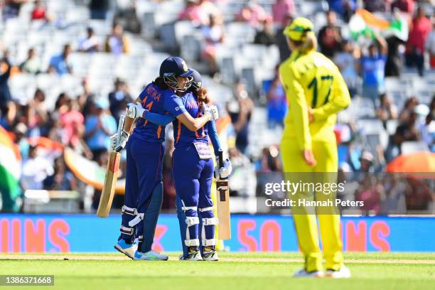 Yastika Bhatia of India celebrates her half century with Mithali Raj during the 2022 ICC Women's Cricket World Cup match between India and Australia...