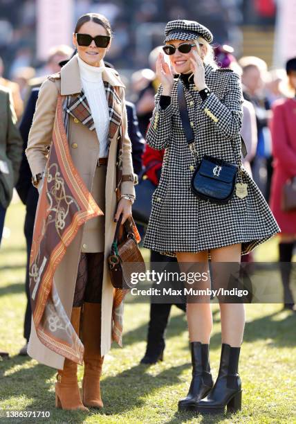 Jade Holland Cooper and Pixie Lott watch the racing as they attend day 4 'Gold Cup Day' of the Cheltenham Festival at Cheltenham Racecourse on March...